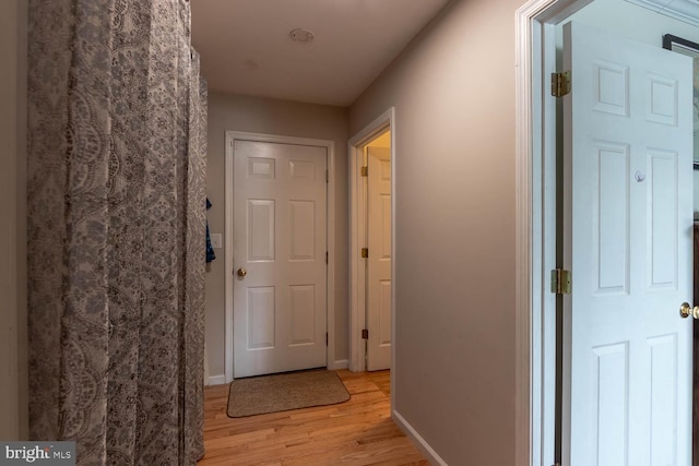 corridor featuring light hardwood / wood-style floors