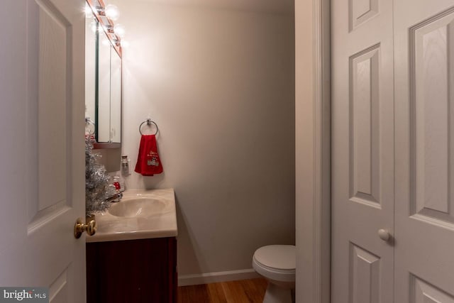 bathroom featuring hardwood / wood-style floors, vanity, and toilet