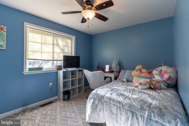 bedroom featuring ceiling fan and light carpet