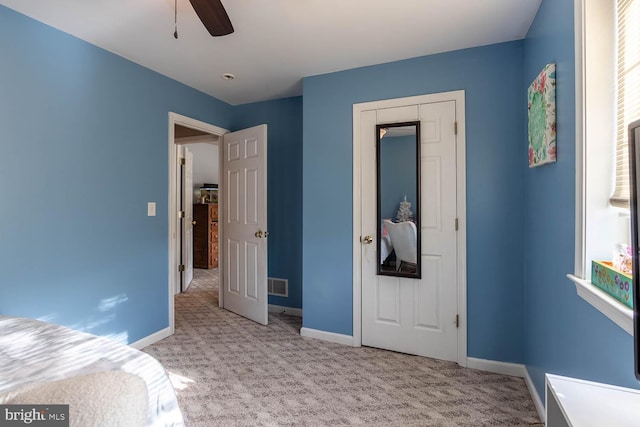 bedroom with ceiling fan and light colored carpet