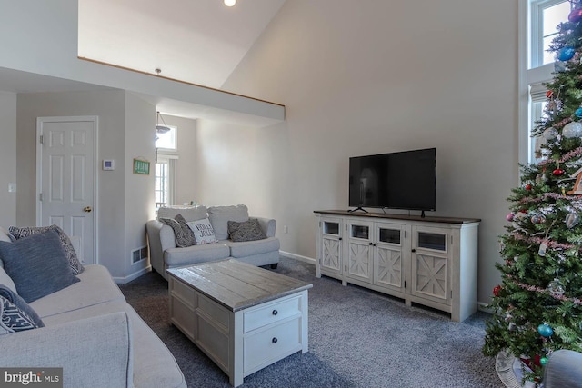 carpeted living room featuring a wealth of natural light and high vaulted ceiling