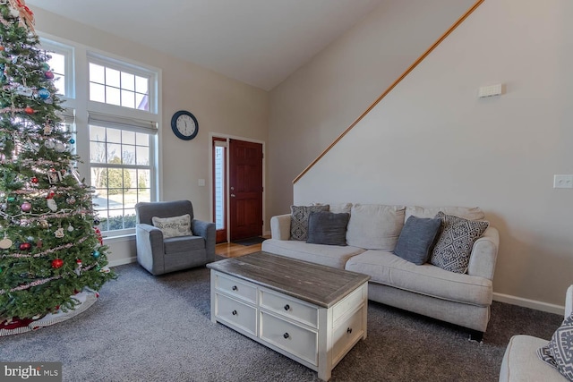 carpeted living room featuring high vaulted ceiling