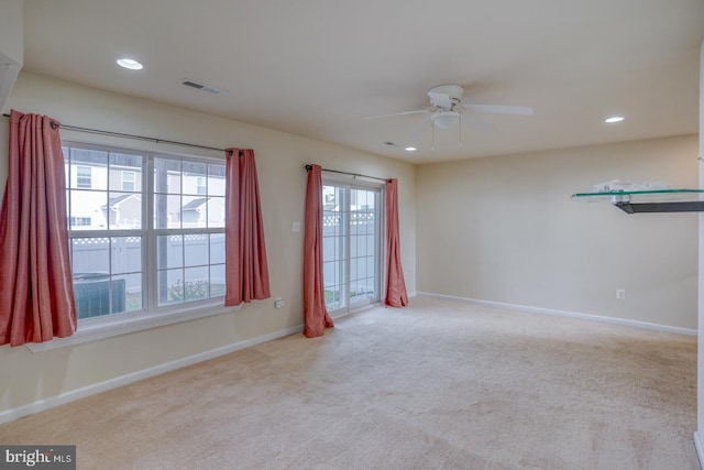 unfurnished room featuring ceiling fan and light colored carpet