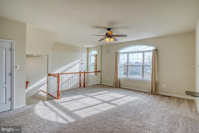 spare room featuring ceiling fan and carpet