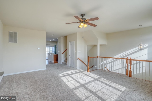 carpeted spare room with ceiling fan