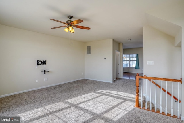 empty room featuring carpet flooring and ceiling fan