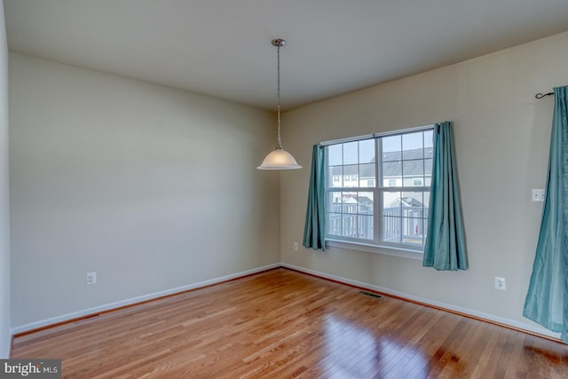 spare room with light hardwood / wood-style floors