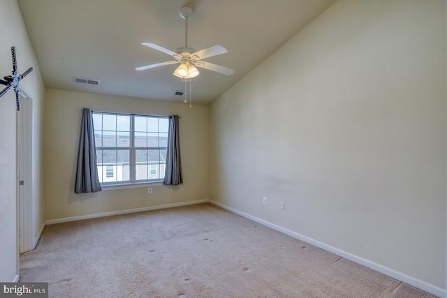 carpeted spare room with ceiling fan