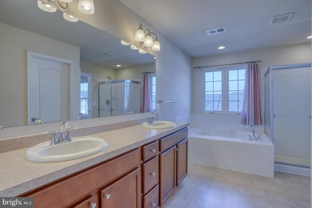 bathroom featuring plus walk in shower, vanity, and tile patterned flooring