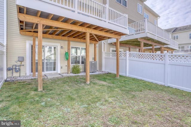 view of yard featuring central air condition unit and a deck