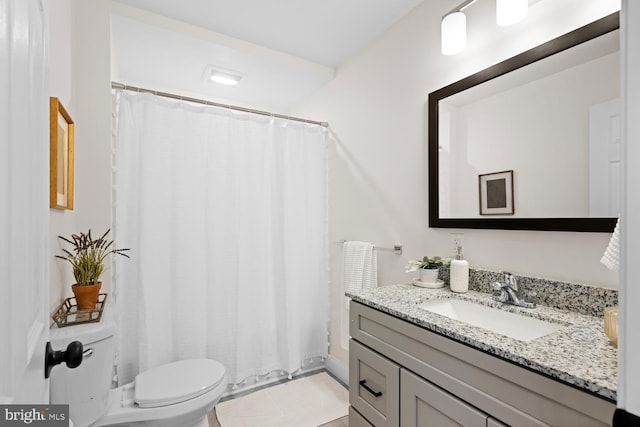 bathroom with tile patterned floors, vanity, and toilet