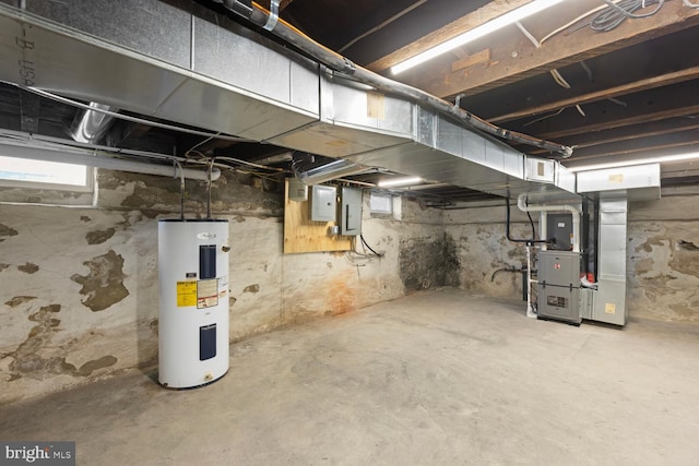 basement featuring electric panel, water heater, and heating unit