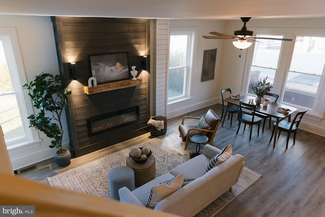 living room featuring hardwood / wood-style flooring, plenty of natural light, and ceiling fan