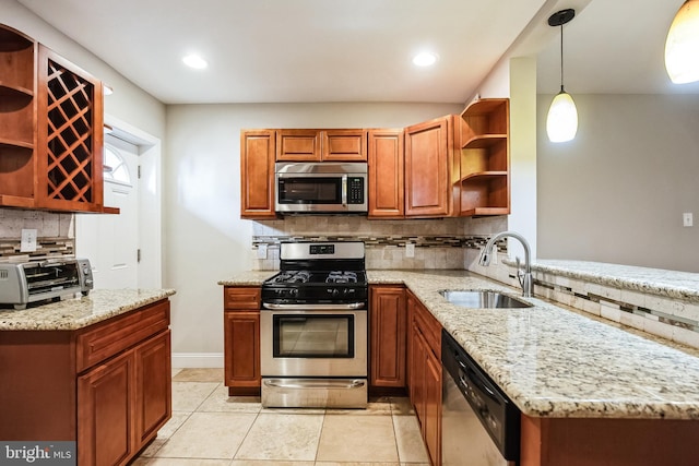 kitchen featuring light stone countertops, hanging light fixtures, light tile patterned floors, appliances with stainless steel finishes, and sink