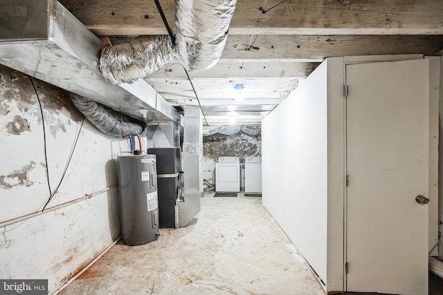 basement featuring washing machine and dryer, water heater, and heating unit