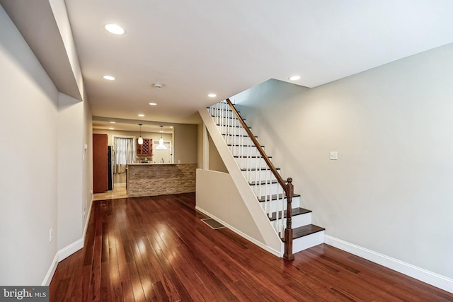 stairs with hardwood / wood-style floors