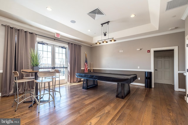 game room featuring visible vents, a tray ceiling, and wood finished floors