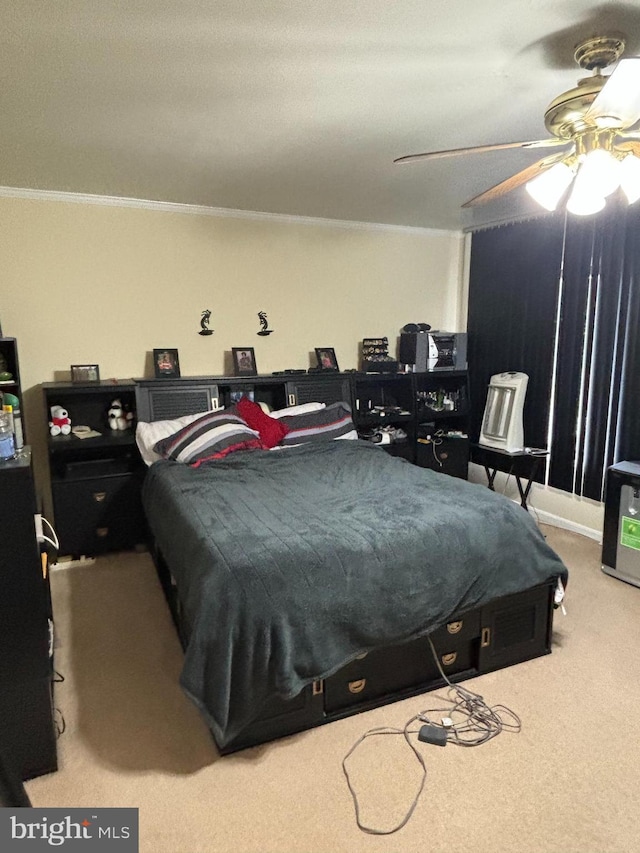 carpeted bedroom featuring ceiling fan and ornamental molding