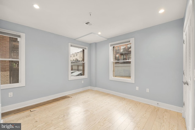 spare room featuring light hardwood / wood-style floors