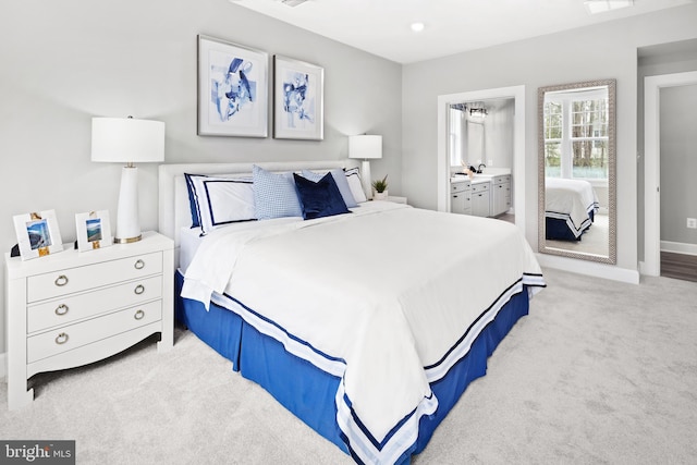 carpeted bedroom with ensuite bathroom