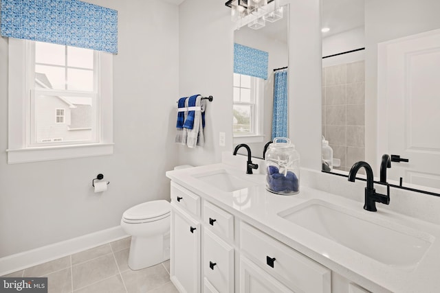 bathroom featuring tile patterned flooring, a shower with curtain, vanity, and toilet