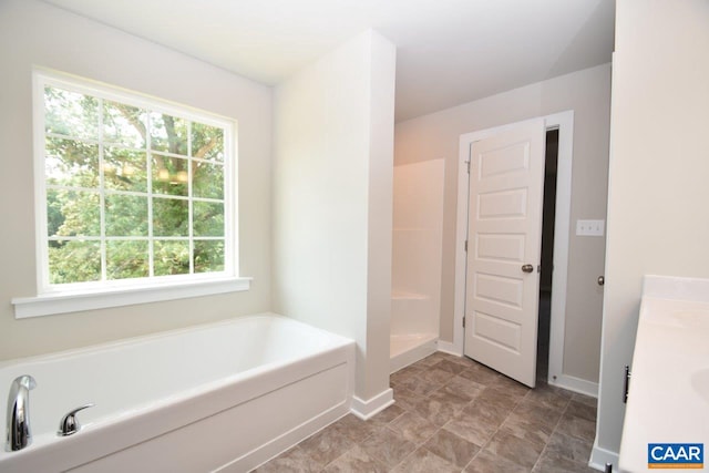 bathroom featuring vanity and a tub