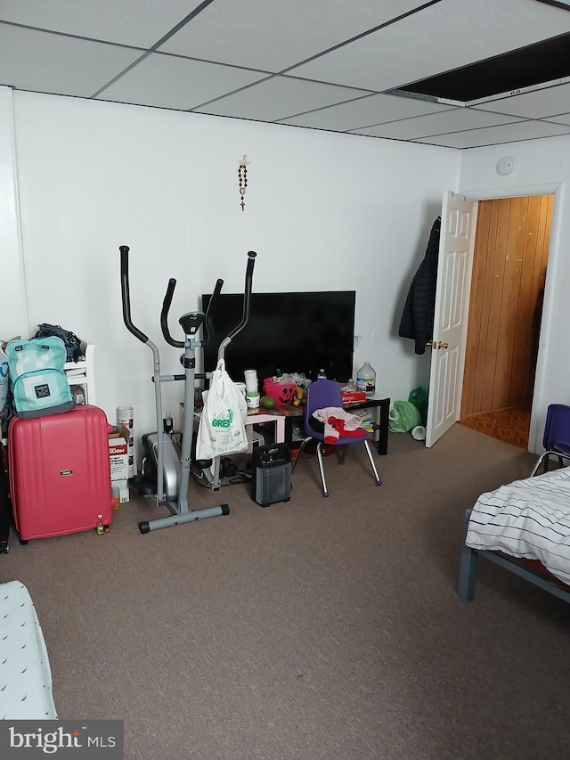 bedroom with carpet flooring and a paneled ceiling