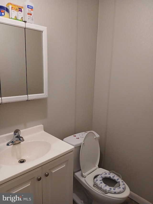 bathroom featuring vanity and toilet