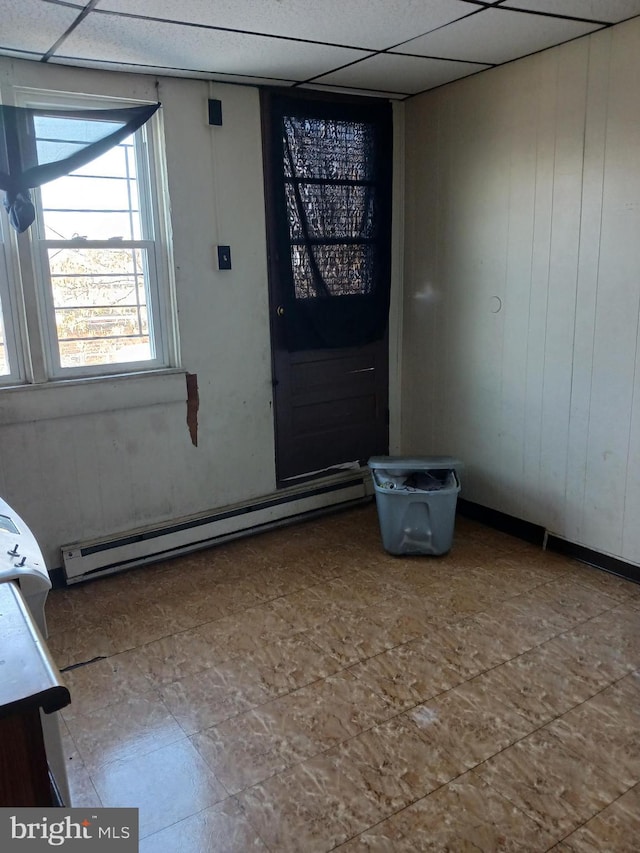 foyer with a paneled ceiling and a baseboard radiator