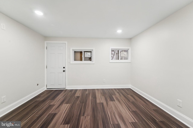 spare room with dark hardwood / wood-style flooring