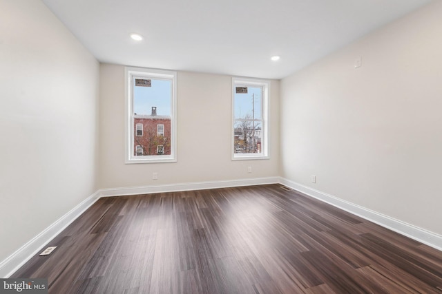 empty room featuring dark hardwood / wood-style flooring