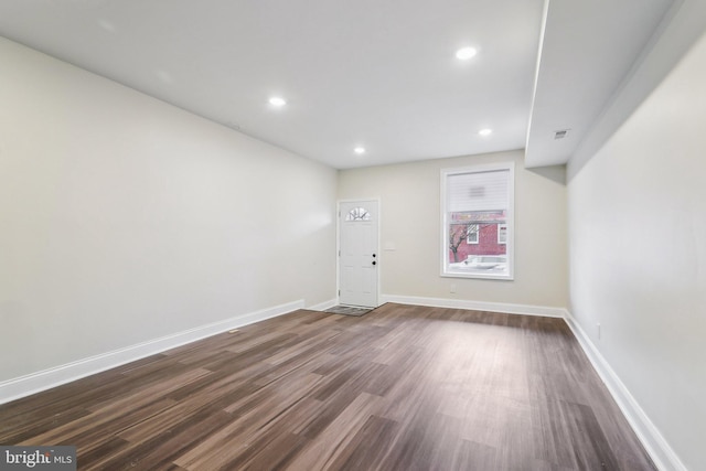 spare room featuring dark hardwood / wood-style flooring