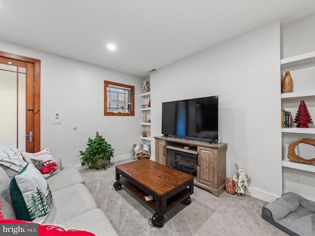 carpeted living room with a fireplace