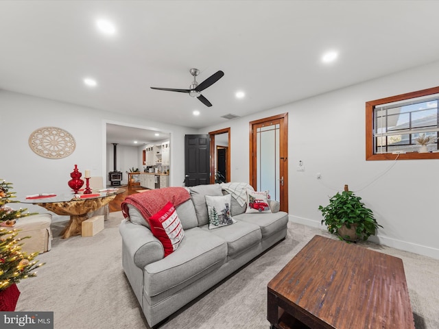 carpeted living room featuring ceiling fan