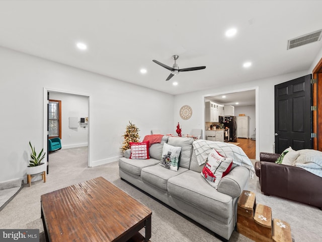 living room with light carpet and ceiling fan