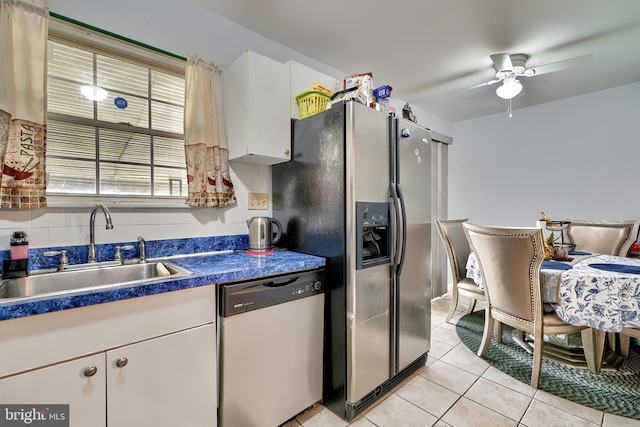 kitchen with ceiling fan, sink, light tile patterned floors, white cabinets, and appliances with stainless steel finishes