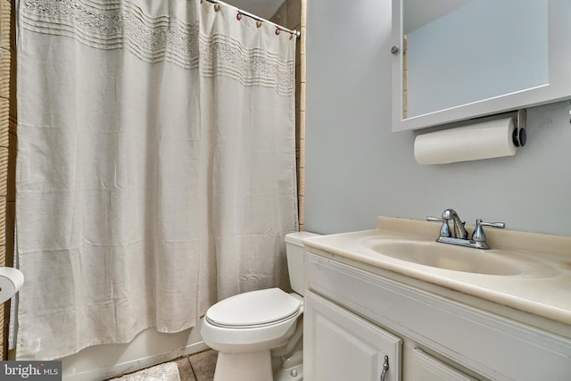 bathroom featuring tile patterned floors, vanity, and toilet