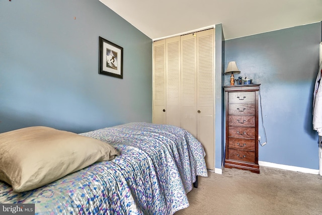 bedroom featuring a closet and light colored carpet