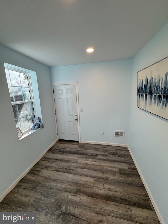 spare room with dark wood-type flooring