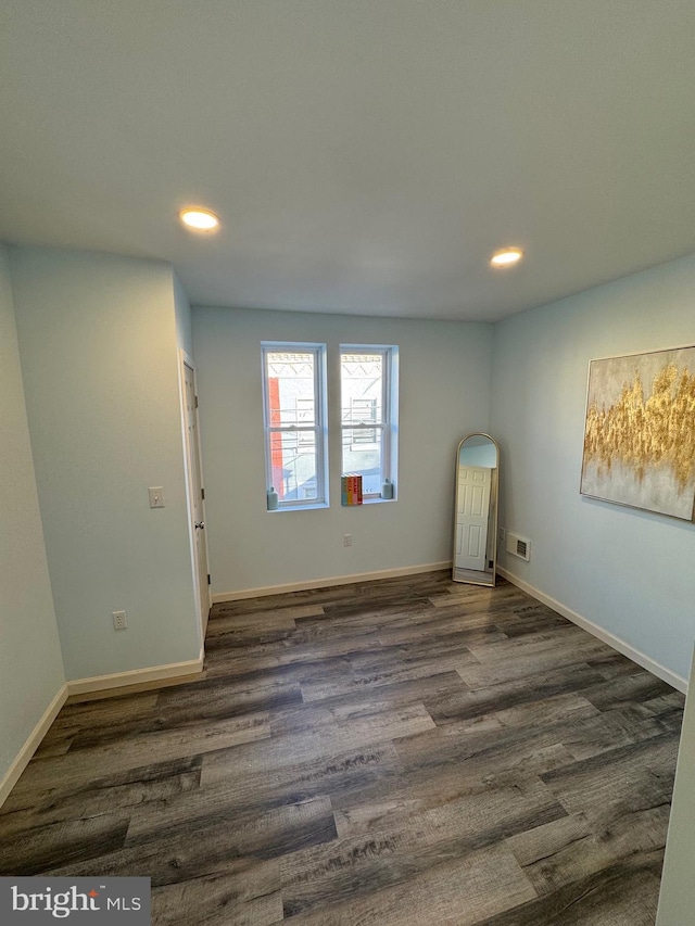 unfurnished room featuring dark hardwood / wood-style floors