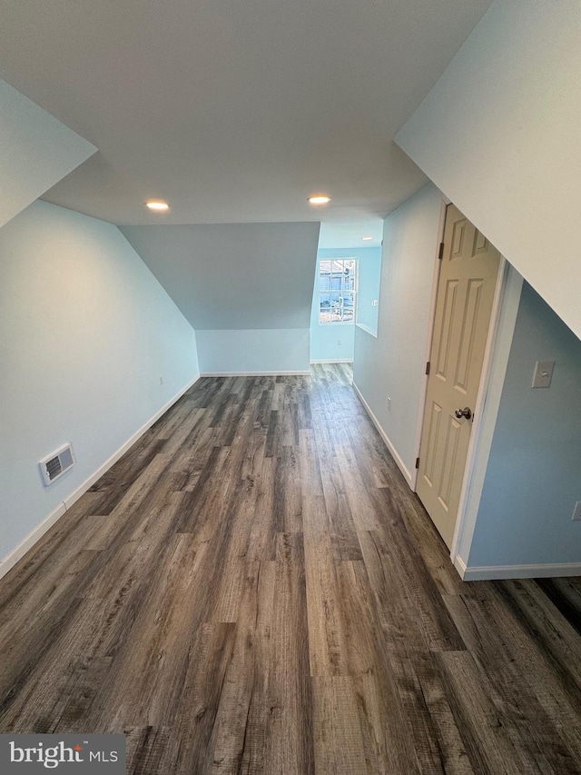 additional living space with dark hardwood / wood-style floors