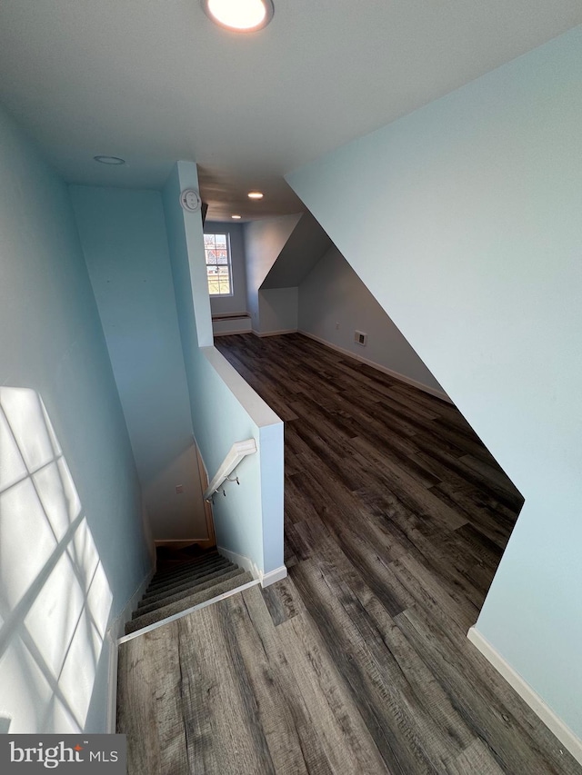 staircase with hardwood / wood-style floors