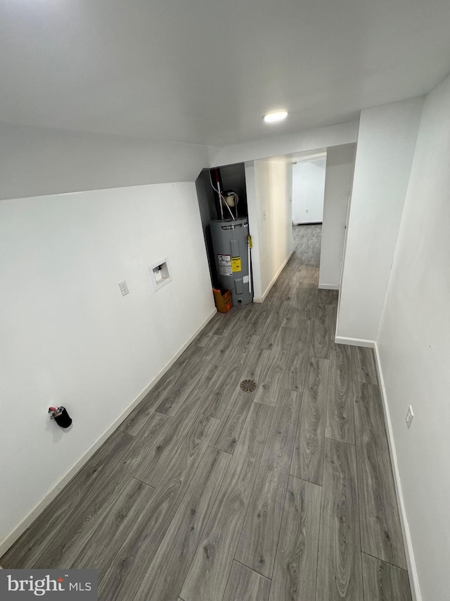 interior space with wood-type flooring and water heater