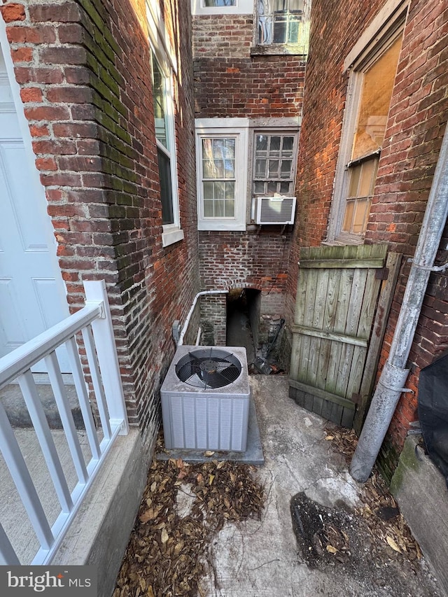 view of patio with central air condition unit and cooling unit