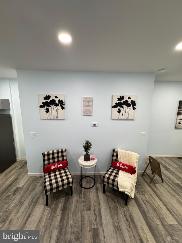 sitting room with wood-type flooring