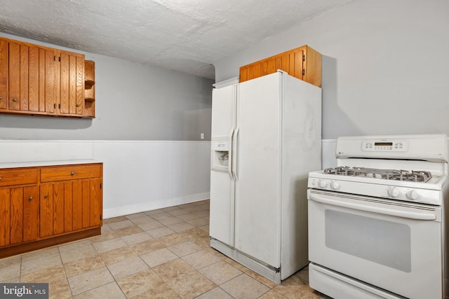 kitchen with brown cabinets, white appliances, open shelves, and light countertops