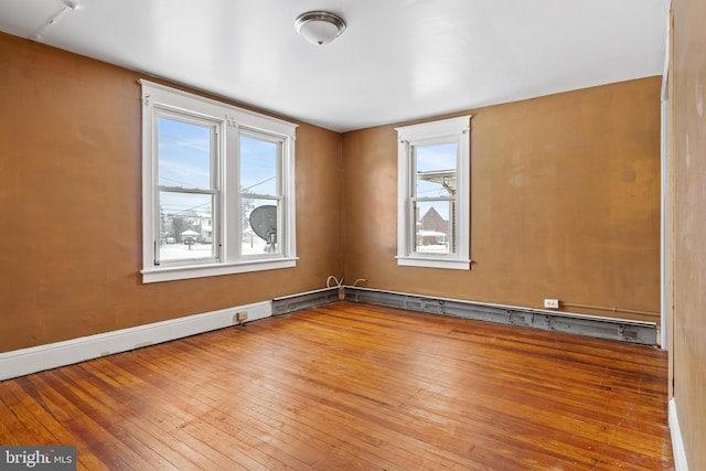 spare room with wood finished floors and baseboards