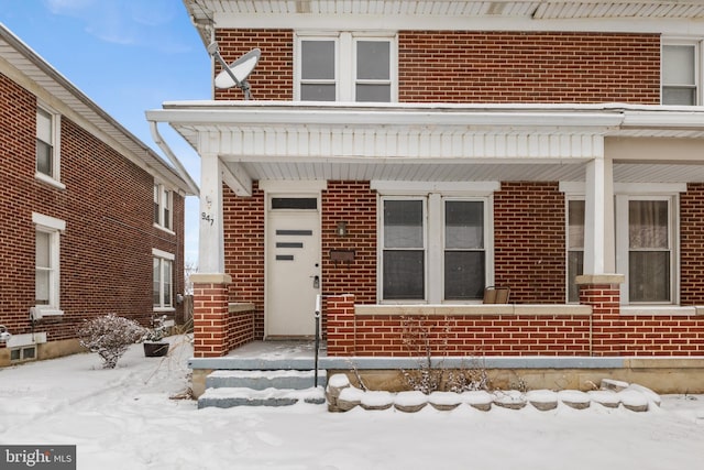 view of snow covered property entrance