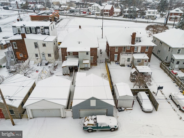 snowy aerial view with a residential view