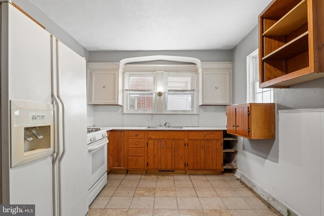 kitchen featuring brown cabinetry, white appliances, and light countertops